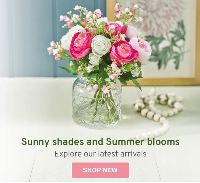Two floral arrangements showcasing vibrant faux Summer flowers in stoneware vases