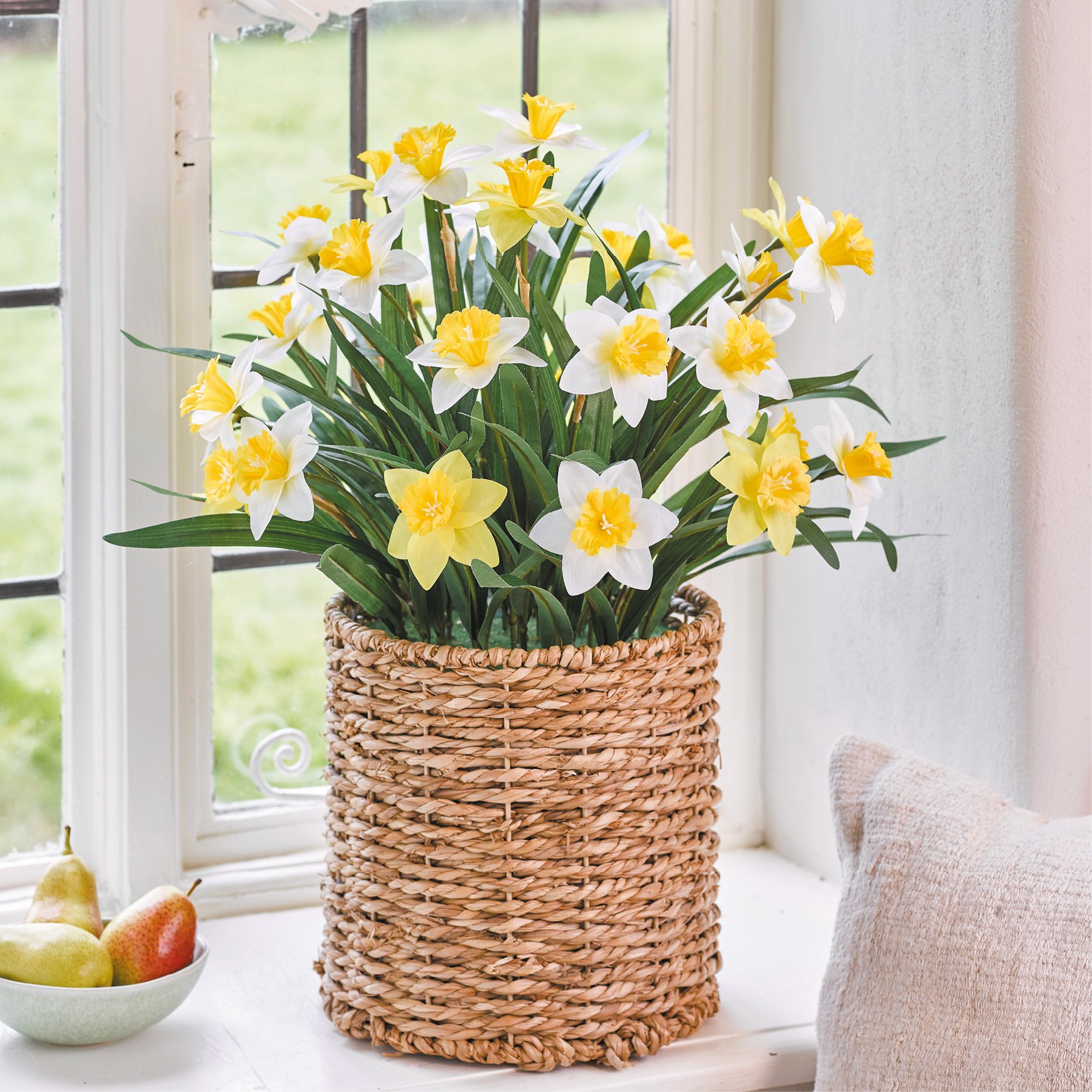 Faux yellow and white daffodils in wicker planter