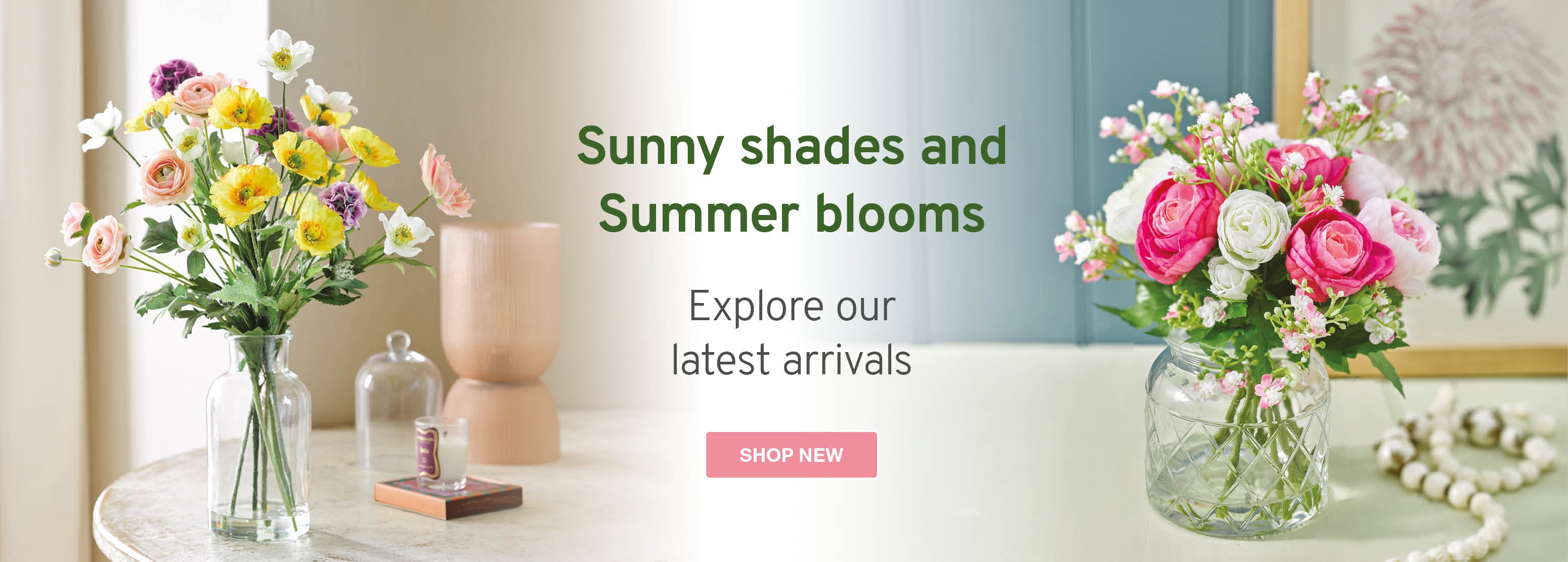 Two floral arrangements showcasing vibrant faux Summer flowers in stoneware vases