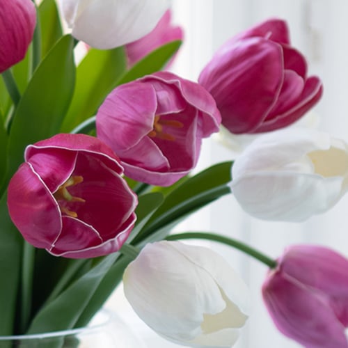 Close up image of faux purple and white tulips