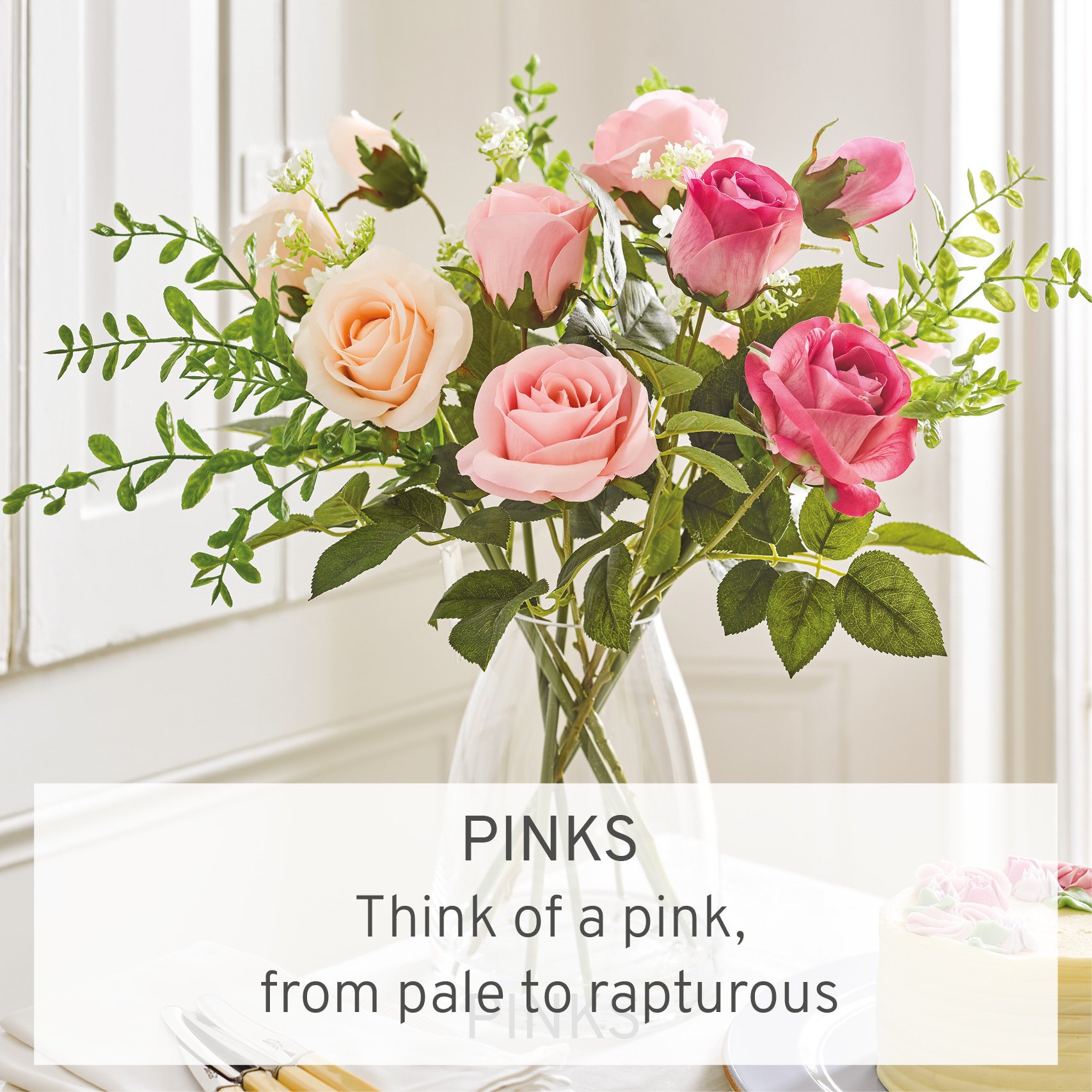 Faux pink roses arranged in glass vase