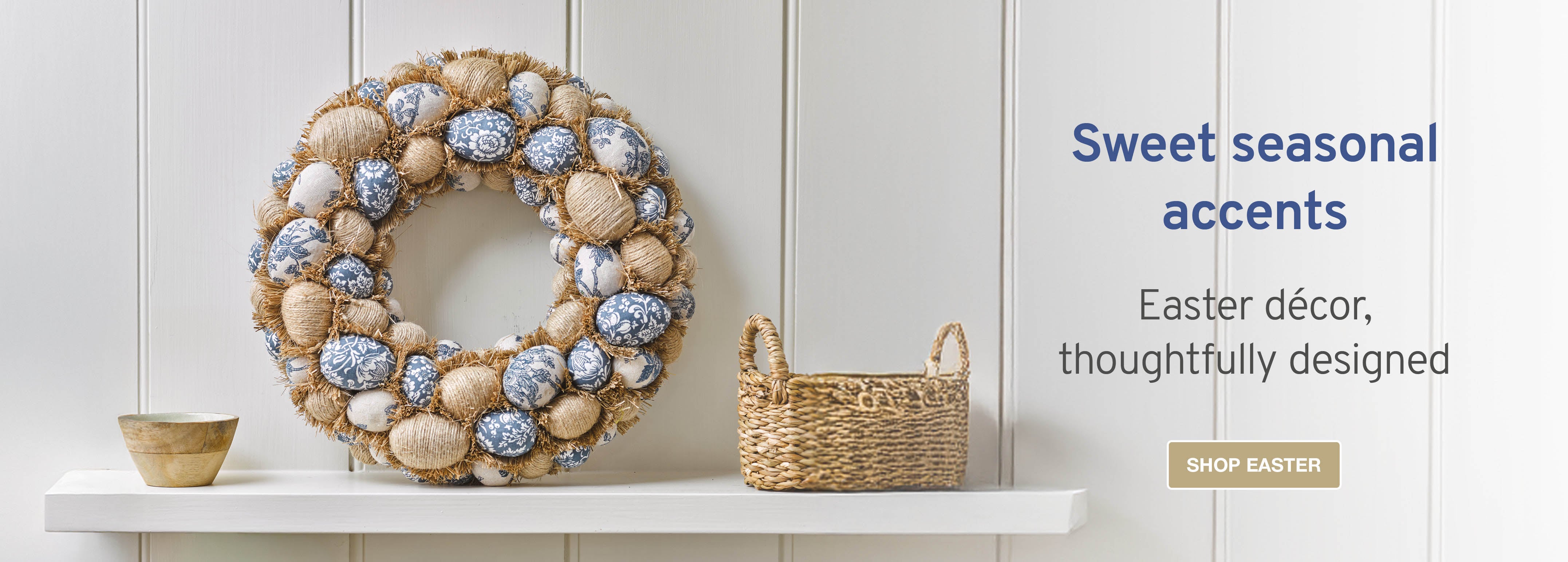 Image of a faux wreath featuring rattan and blue easter eggs