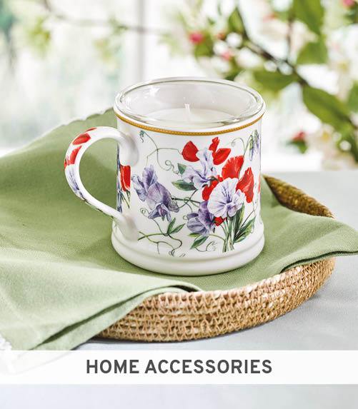 Candle inside mug designed with bright flowers