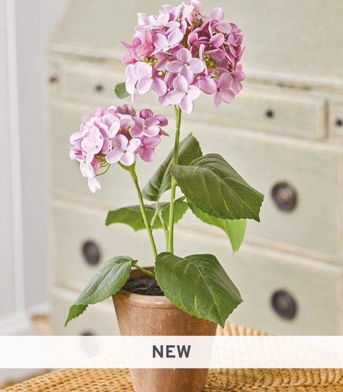 Faux purple hydrangea in brown pot